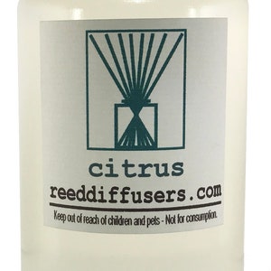 May include: A clear glass bottle with a white cap filled with a light yellow liquid. The label reads "citrus reeddiffusers.com" and "Keep out of reach of children and pets - Not for consumption."