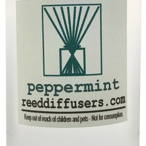 May include: A clear glass bottle with a white label that reads "peppermint reeddiffusers.com". The label also includes a graphic of a diffuser with reeds and the text "Keep out of reach of children and pets - Not for consumption."