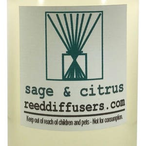 May include: A clear glass bottle with a white cap filled with a light yellow liquid. The label reads "sage & citrus reeddiffusers.com" and "Keep out of reach of children and pets - Not for consumption."