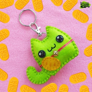 Chaveiro de pelúcia e pingente de bolsa em forma de gato Maneki Neko verde Kawaii - 7,6 cm de altura x 10,1 cm de largura