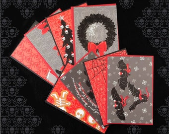 May include: Set of six red and black holiday greeting cards with various spooky and festive designs. The cards feature illustrations of a Christmas tree, a wreath, bats, and the text "You're my kind of crazy!"