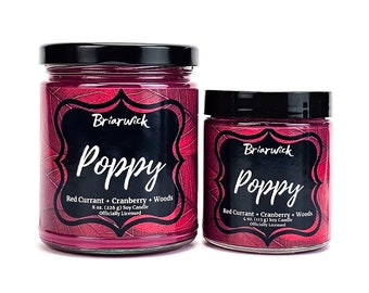 May include: Two glass candle jars with black lids. The larger jar is 8 ounces and the smaller jar is 4 ounces. Both jars have a red currant, cranberry, and woods scented soy candle. The label on the jars says "Briarwick Poppy" and "Officially Licensed".
