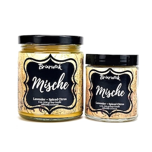 May include: Two glass jars of soy candles with black lids. The labels read "Briarwick Mische Lavender + Spiced Citrus." The larger jar contains 8 oz (226 g) of candle, and the smaller jar contains 4 oz (113 g).