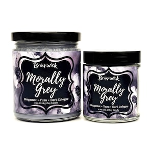 two jars with labels on them sitting next to each other