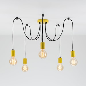 May include: A modern ceiling light fixture with five exposed bulbs. The fixture has a yellow canopy and bulb holders, black cords, and clear Edison-style bulbs. The light is suspended from a white ceiling.