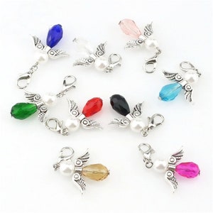 May include: Assortment of ten angel charm pendants with crystal beads in various colours, including green, blue, red, black, pink, and clear. Each charm features a silver angel with wings and a pearl bead.