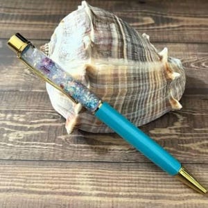 Penna a sfera galleggiante con glitter e stelle marine