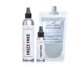 May include: Three silver spray bottles with black tops and labels that say "a simple planet" and "Frizz Free". The bottles are labeled with different scents: Sweet Orange, Lavender, and a larger bottle that says "Product 17 fl oz".