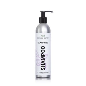 May include: A silver bottle of clarifying lavender shampoo with a black pump top. The bottle is labeled "a simple planet" and "Clarifying Shampoo Lavender 9 fl oz (266 ml)".