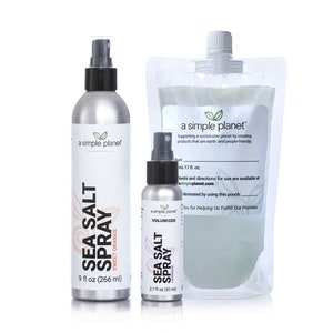May include: Two silver spray bottles with black tops and labels that say "a simple planet" and "Sea Salt Spray" with different scents: Sweet Orange and Lavender. The larger bottle is 9 fl oz (266 ml) and the smaller bottle is 2.7 fl oz (80 ml).  A clear plastic pouch with a label that says "a simple planet" and "Supporting a sustainable planet by creating products that are earth and people-friendly".