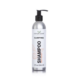 May include: A silver bottle of clarifying shampoo with a black pump top. The bottle is labeled "a simple planet" and "Clarifying Shampoo Sweet Orange". The bottle contains 9 fl oz (266 ml) of shampoo.