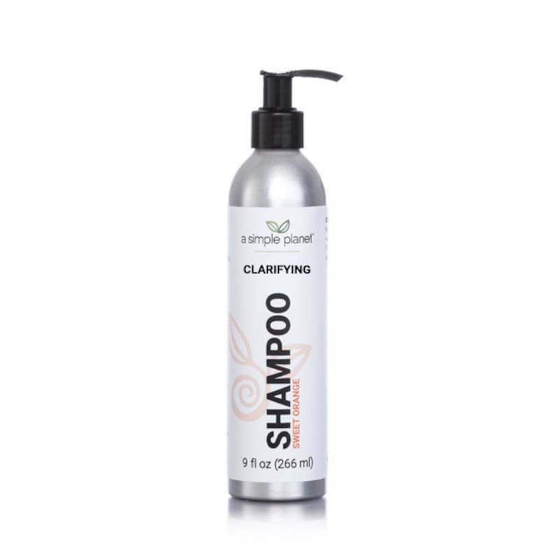 May include: A silver bottle of clarifying shampoo with a black pump top. The bottle is labeled "a simple planet" and "Clarifying Shampoo Sweet Orange". The bottle contains 9 fl oz (266 ml) of shampoo.