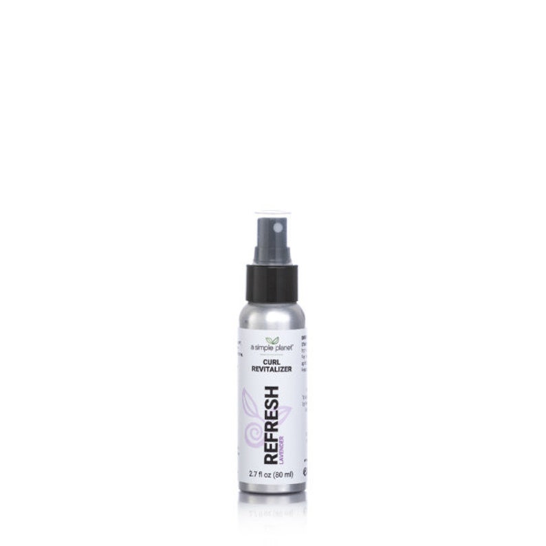 May include: A silver spray bottle with a black cap and a white label. The label says "a simple planet" and "CURL REVITALIZER REFRESH LATHER 2.7 fl oz (80 ml)".