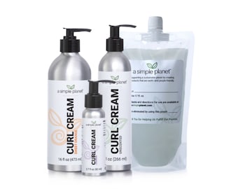 May include: Three silver bottles of curl cream from a simple planet. The bottles are labeled with the product name, size, and scent. The largest bottle is 16 fluid ounces, the middle bottle is 1 ounce, and the smallest bottle is 2.7 fluid ounces. The bottles are on a white background.