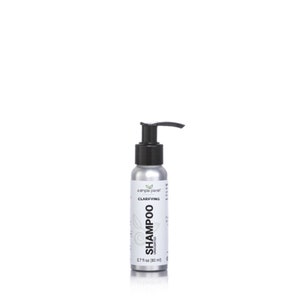 May include: A silver bottle of clarifying shampoo with a black pump dispenser. The bottle is labeled "a simple planet" and "Clarifying Shampoo Unscented" with a green leaf logo. The bottle is 2.7 fl oz (80 ml).