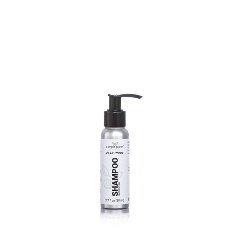 May include: A silver bottle of clarifying shampoo with a black pump dispenser. The bottle is labeled "a simple planet" and "Clarifying Shampoo Unscented" with a green leaf logo. The bottle is 2.7 fl oz (80 ml).