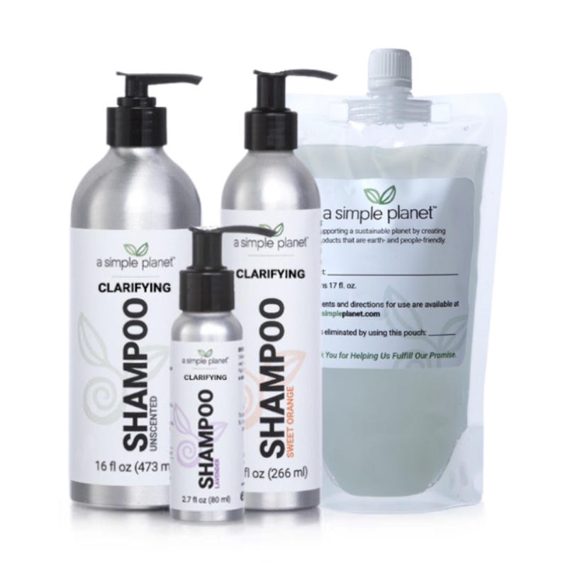 May include: Three silver bottles of clarifying shampoo from a simple planet. The bottles are labeled with the product name, scent, and size. The bottles are arranged from left to right: unscented, sweet orange, and lavender. The bottles are on a white background.
