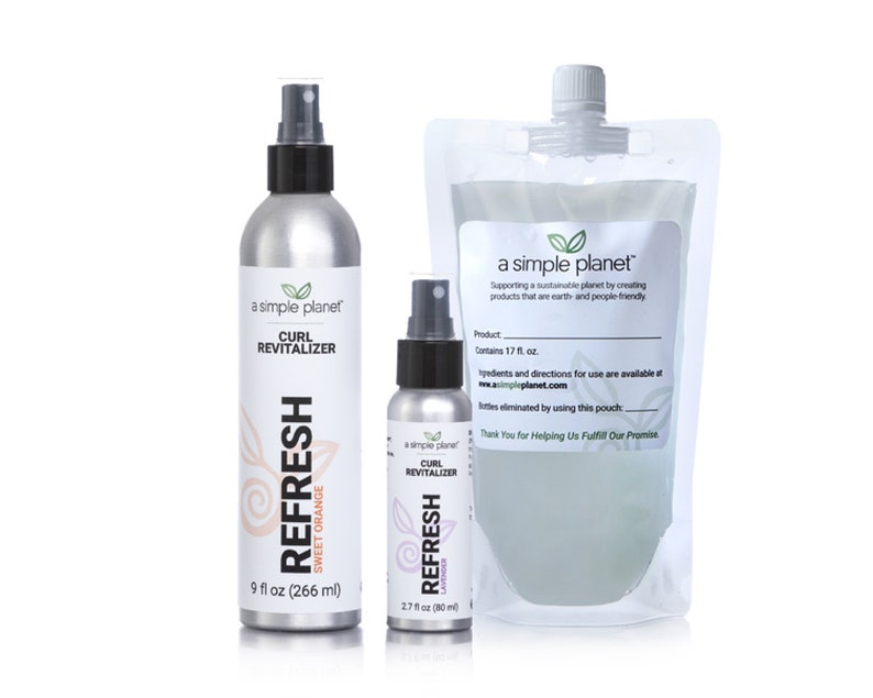 May include: Three silver spray bottles with a simple planet logo and the text "Curl Revitalizer" and "Refresh". The bottles are labeled with different scents: Sweet Orange, Lavender, and Unscented. The bottles are 9 fl oz, 2.7 fl oz, and 17 fl oz.