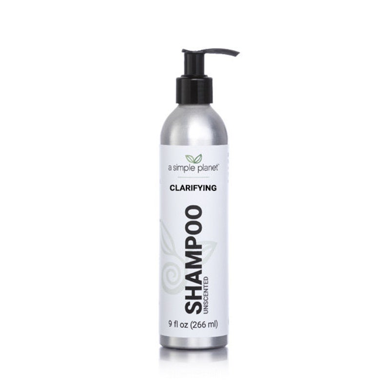 May include: A silver bottle of clarifying shampoo with a black pump top. The bottle is labeled "a simple planet" and "Clarifying Shampoo Unscented". The bottle contains 9 fl oz (266 ml) of shampoo.
