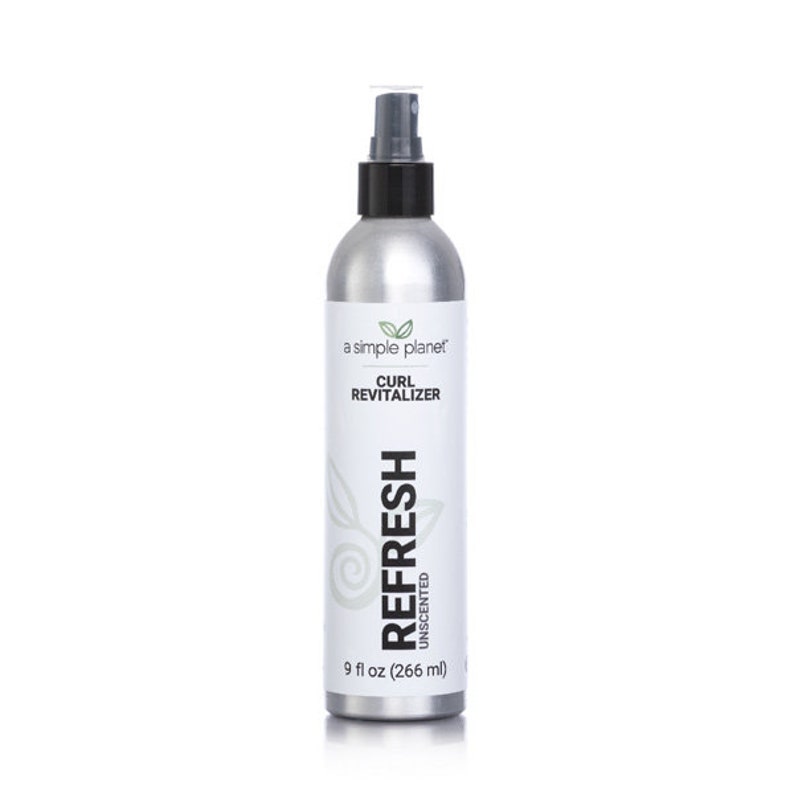 May include: A silver spray bottle with a black cap and label. The label reads "a simple planet" and "Curl Revitalizer Refresh Unscented 9 fl oz (266 ml)"