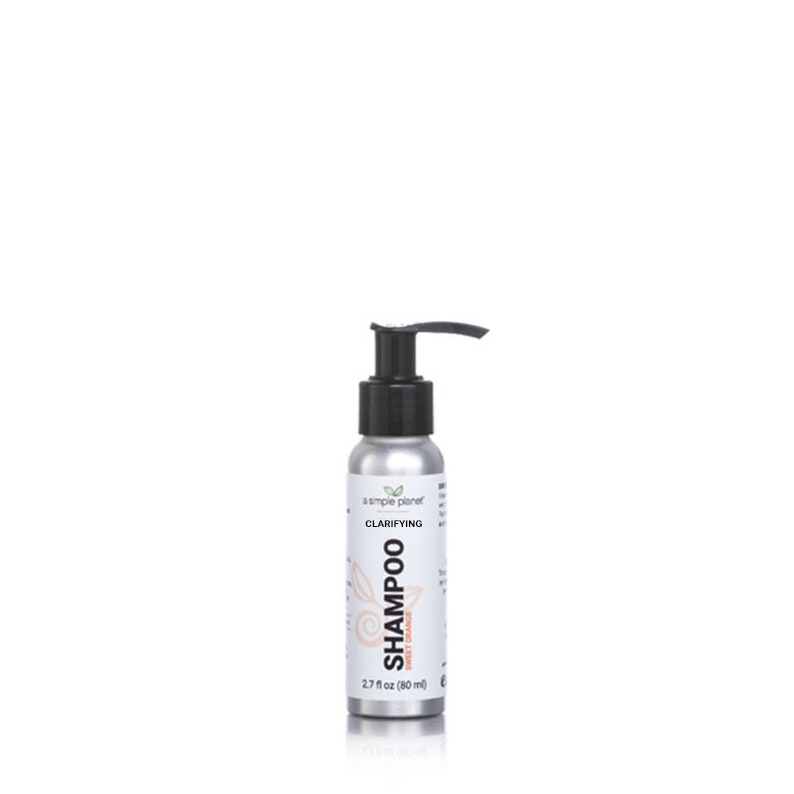 May include: A silver bottle of clarifying shampoo with a black pump top. The bottle is labeled "a simple planet" and "Clarifying Shampoo Sweet Orange". The bottle is 2.7 fl oz (80 ml).