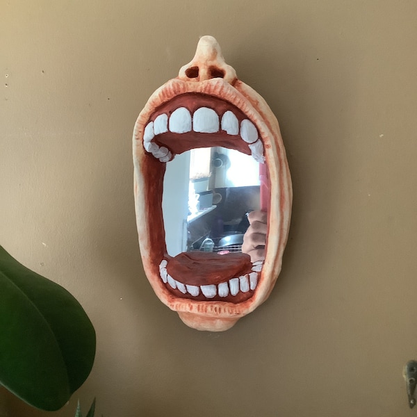 Gaping gob hanging mirror.