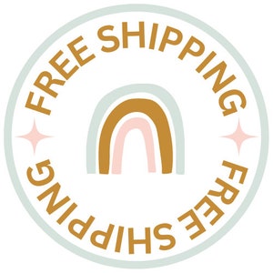 May include: A light blue circle with the text "FREE SHIPPING" in a gold color around the edge. A rainbow with a light blue, pink, and gold color scheme is in the center of the circle.