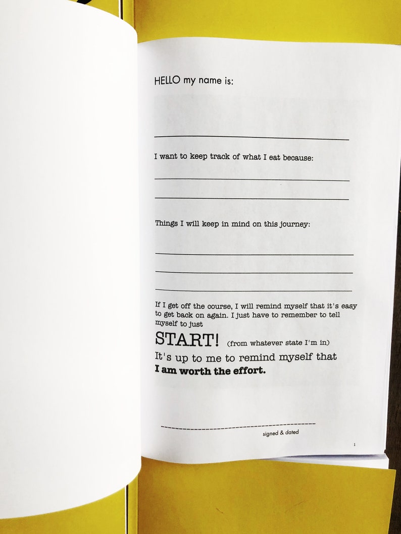 May include: A yellow and white journal with the text "HELLO my name is:" and "START! (from whatever state I'm in) It's up to me to remind myself that I am worth the effort."  The journal is open to a blank page with lines for writing.