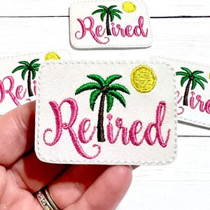 May include: Embroidered white patches with the word "Retired" in pink script, a green palm tree, and a yellow sun. The patches are rectangular with rounded corners. Several patches are visible.