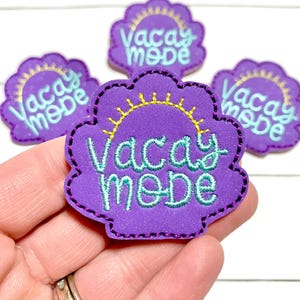 May include: Purple, scalloped-edge patch with the words "Vacay Mode" in teal script and a yellow sun design. The patch has a black stitched border. Several patches are visible.