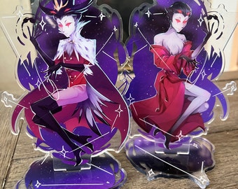 May include: Two acrylic character stands featuring a purple and black galaxy background with white stars. The characters are dressed in red and black clothing. The stands are approximately 4 inches tall.