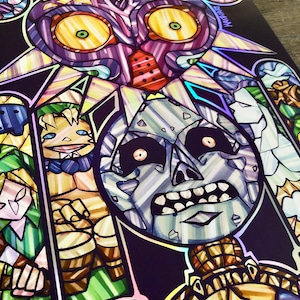May include: A stained glass style illustration of characters from the Legend of Zelda video game series. The image features Link, Ganondorf, and Majora's Mask. The background is a dark purple with iridescent accents.