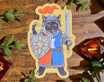 May include: A sticker featuring a black cat dressed as a knight, wearing a helmet and holding a sword and shield. The shield has a sunburst design. The cat's armor is blue and red. The sticker is surrounded by green leaves and dice.