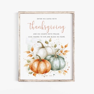 May include: Watercolor print featuring three pumpkins in shades of orange, white, and green, with autumn leaves. The text reads "Enter His Gates with Thanksgiving" and other related phrases. The artwork is framed in a rustic wooden frame.