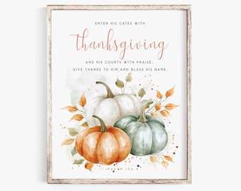 May include: Watercolor print featuring three pumpkins in shades of orange, white, and green, with autumn leaves. The text reads "Enter His Gates with Thanksgiving" and other related phrases. The artwork is framed in a rustic wooden frame.