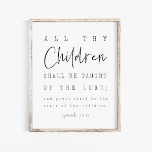 May include: A framed print with a white background and black text. The text reads "ALL THY Children SHALL BE TAUGHT OF THE LORD; and great shall be the peace of thy children. Isaiah 54:13". The frame is a light brown color.