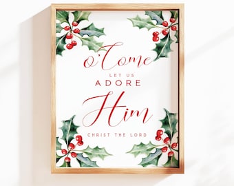 May include: A framed print with a white background and the words "O Come Let Us Adore Him Christ The Lord" in red script. Holly and berry illustrations are in each corner. The frame is made of light brown wood.
