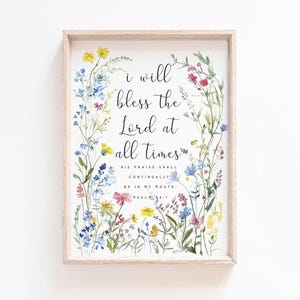 Könnte beinhalten: Gerahmter Kunstdruck mit dem Text "I will bless the Lord at all times", umgeben von Aquarellblumen in Gelb, Blau, Rosa und Rot. Der Rahmen ist helles Holz.