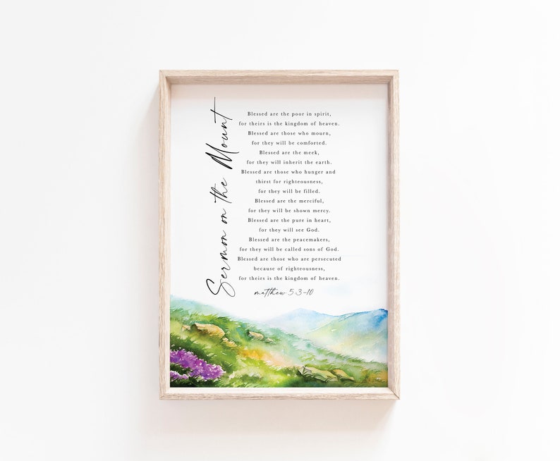 May include: A framed print featuring the text "Sermon on the Mount" in elegant script. The artwork includes a watercolor landscape with mountains and flowers in shades of green, blue, and purple. The text is from Matthew 5:3-10.