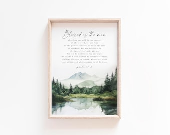 May include: A watercolor painting of a forest scene with a lake in the foreground. The painting is framed in a light wood frame. The text "Blessed is the men who does not walk in the counsel of the wicked, or set foot on the path of sinners, or sit in the seat of mockers. But his delight is in the law of the Lord, and on His law he meditates day and night. He is like a tree planted by streams of water, yielding its fruit in season, whose leaf does not wither, and who prospers in all he does. Psalm 1:1-3" is printed on the painting.