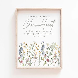 May include: A framed print with the text "Create in me a Clean Heart" and "o God, and renew a right spirit within me Psalm 51:10." The bottom of the print features a watercolor floral design with blue, yellow, and pink flowers.