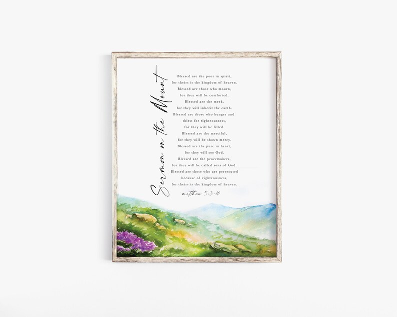 May include: Framed print featuring the text "Sermon on the Mount" in elegant script. The artwork includes a watercolor landscape with green hills, purple flowers, and a blue sky. The text is a passage from Matthew 5:3-10.