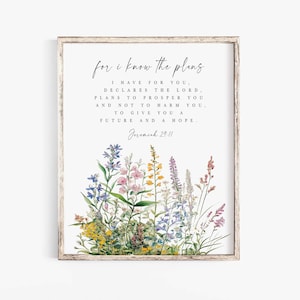 May include: A framed print with the text "for I know the plans" and a Bible verse. The artwork features a watercolor floral design at the bottom with various wildflowers in shades of blue, pink, yellow, and purple.