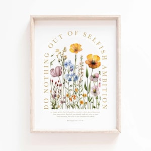 Könnte beinhalten: Ein gerahmter Kunstdruck mit einer Aquarellillustration von Wildblumen in Gelb-, Orange-, Lila- und Blautönen. Der Text "DO NOTHING OUT OF SELFISH AMBITION" wölbt sich über den Blumen, darunter ein Bibelvers.