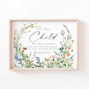 Può includere: Stampa incorniciata con la scritta "For This Child We Have Prayed", circondata da un bordo floreale. La cornice è marrone chiaro e i fiori sono rosa, blu e gialli.