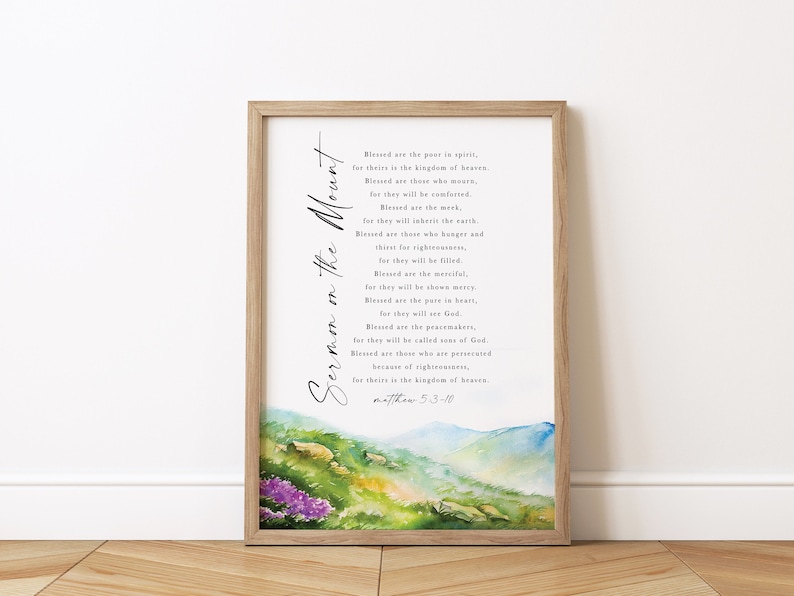 May include: A framed print featuring the text "Sermon on the Mount" in elegant script. The artwork includes a watercolor landscape at the bottom with green hills, purple flowers, and blue mountains. The text is from Matthew 5:3-10.