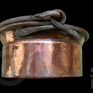 May include: A copper pot with a hinged lid and a metal handle. The pot has a hammered finish and is in good condition.
