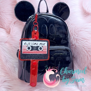 May include: A black Mickey Mouse backpack with a red and white cassette tape keychain that says "Awesome Mix".