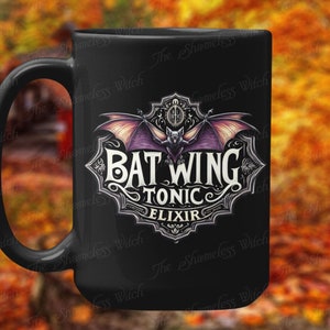 May include: Black ceramic mug with a graphic of a bat with spread wings and the text "Bat Wing Tonic Elixir".