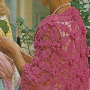 May include: A pink crocheted shawl with a lacy pattern. The shawl is draped over a woman's shoulders. The text "MICAVINTAGE" is visible in the bottom of the image.